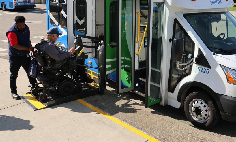 A rider boarding a bus using the wheelchair ramp