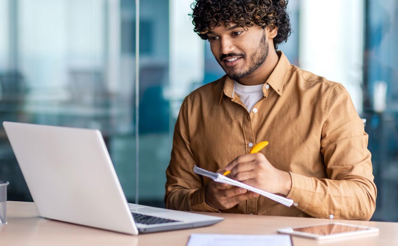 A small-business owner working at a laptop