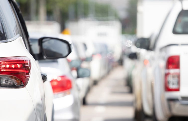 Cars queued bumper to bumper in slow traffic