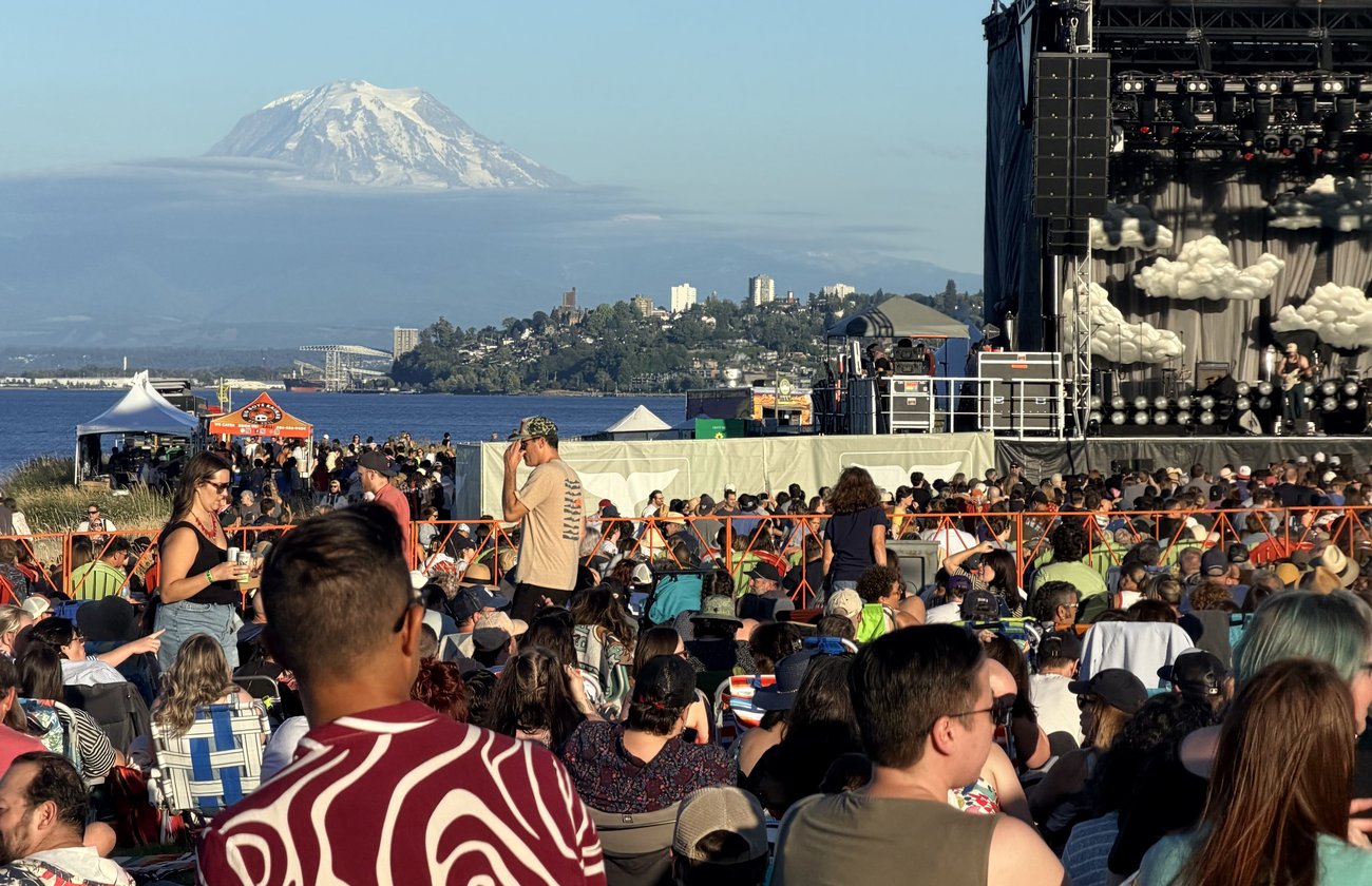 Crowd at an outdoor concert at Dune Peninsula with Mount Rainier in the distance